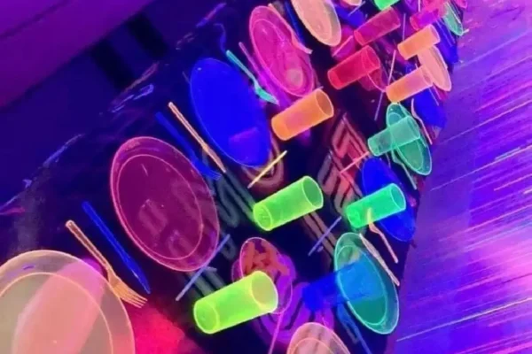 A bunch of neon plates and cups on the table