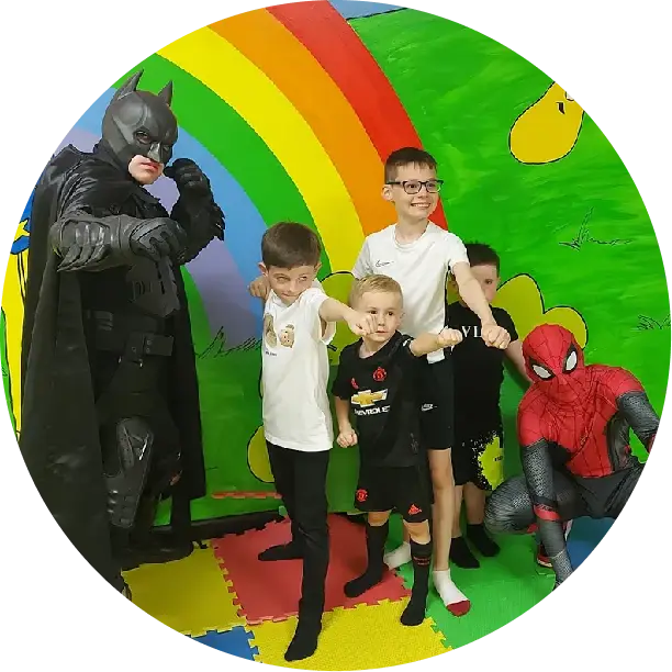 Ellipse-17 (1) A group of kids posing for a picture with batman.